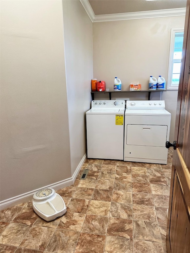 washroom featuring washer and clothes dryer and ornamental molding