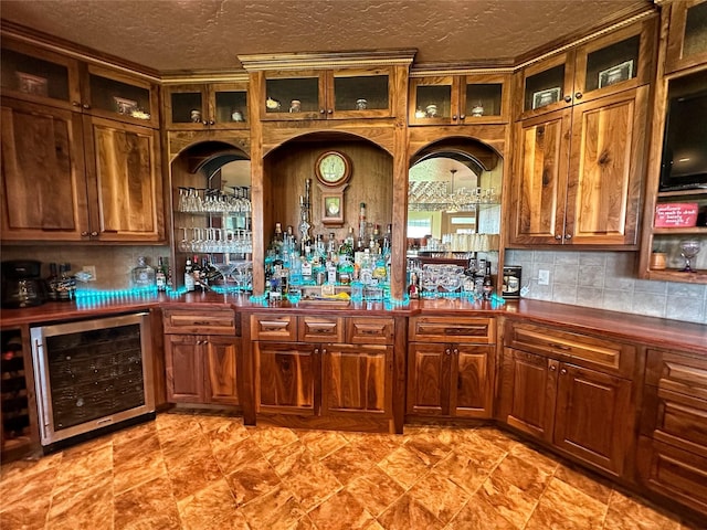 kitchen featuring decorative backsplash, a textured ceiling, and beverage cooler