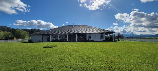 back of property featuring a yard