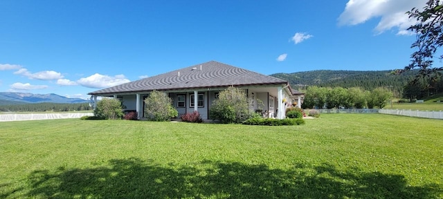 exterior space featuring a mountain view and a yard