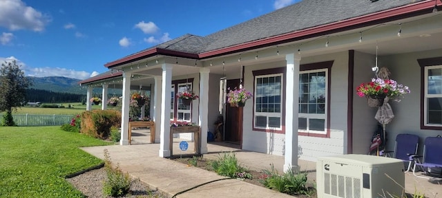 property entrance with a porch and a lawn