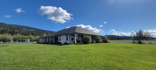 view of home's exterior featuring a mountain view and a yard