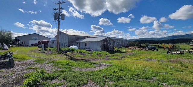 exterior space with a mountain view and an outdoor structure