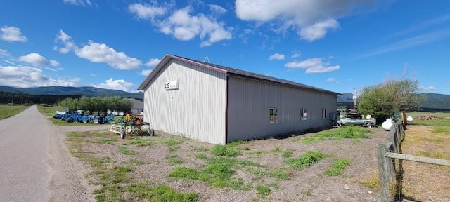 view of side of home with a mountain view