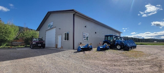 view of property exterior featuring an outbuilding and a garage