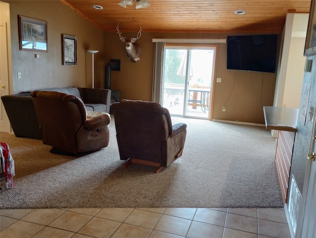 carpeted living room with a wood stove, wood ceiling, and vaulted ceiling