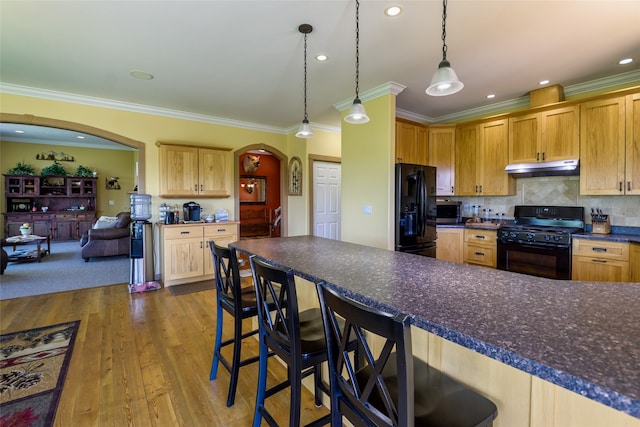 kitchen featuring light hardwood / wood-style flooring, backsplash, crown molding, light brown cabinetry, and black appliances