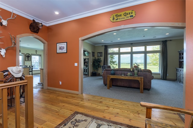 entrance foyer with light wood-type flooring and ornamental molding