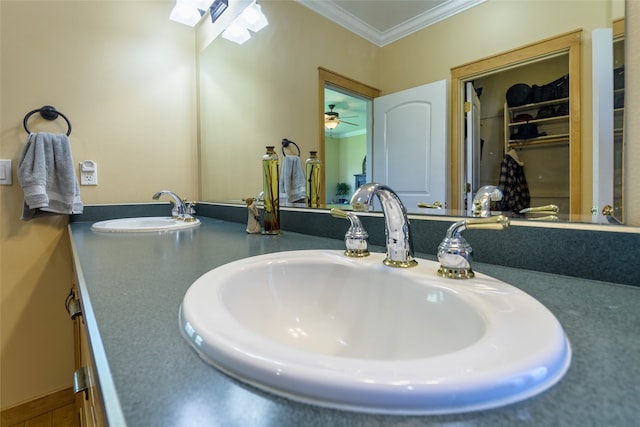 bathroom featuring a tub, crown molding, and vanity