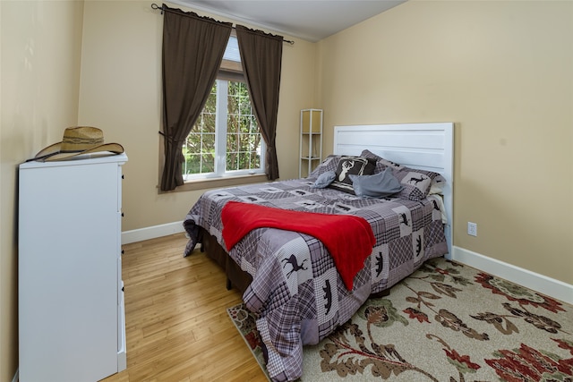 bedroom featuring hardwood / wood-style floors and a closet