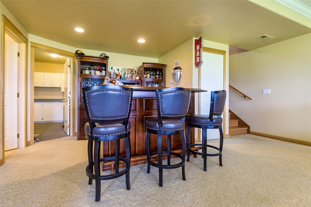 playroom with indoor bar, carpet floors, and crown molding