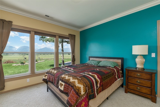 carpeted bedroom with a closet and ornamental molding