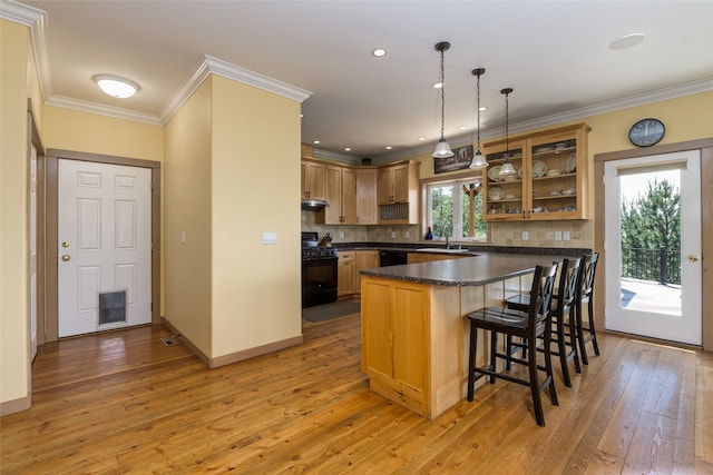 dining space featuring a notable chandelier, light wood-type flooring, ornamental molding, and a wall unit AC