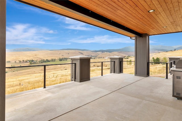 view of patio / terrace featuring a mountain view and a rural view