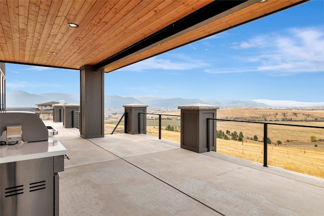 view of patio / terrace with exterior kitchen and a mountain view