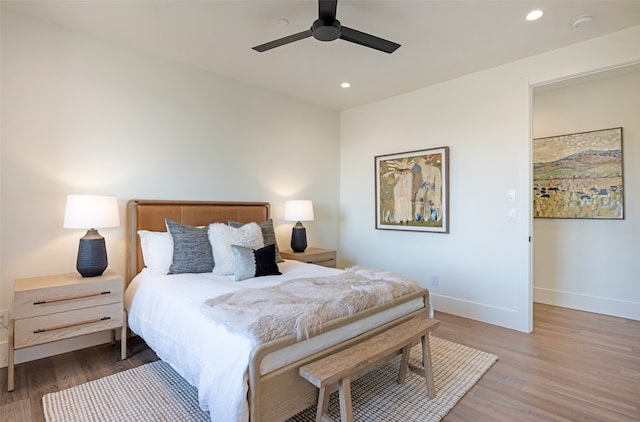 bedroom with ceiling fan and wood-type flooring