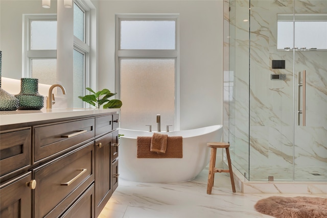 bathroom featuring vanity, a wealth of natural light, and separate shower and tub