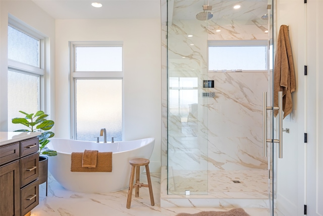 bathroom featuring separate shower and tub and vanity