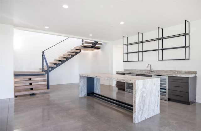 bar with light stone counters and beverage cooler