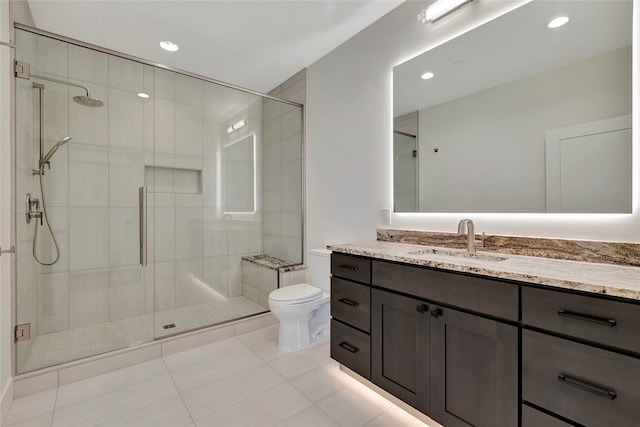 bathroom featuring vanity, toilet, an enclosed shower, and tile patterned flooring