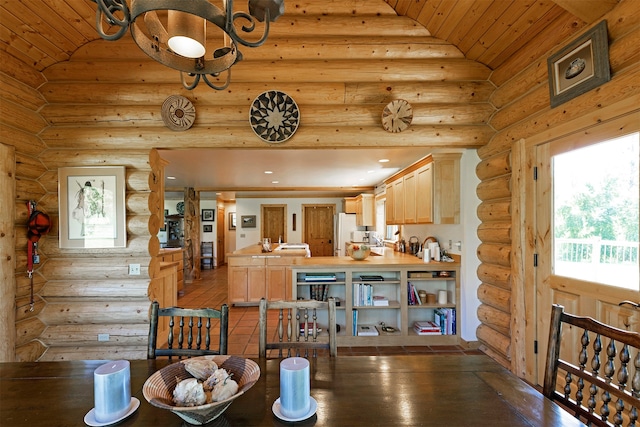 dining room with log walls and vaulted ceiling