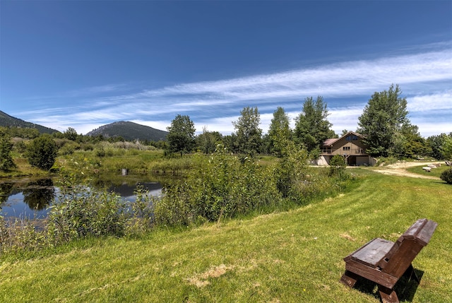 exterior space with a water and mountain view