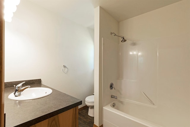 full bathroom with bathing tub / shower combination, toilet, vanity, and wood-type flooring