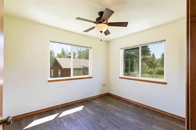 spare room with ceiling fan and dark wood-type flooring