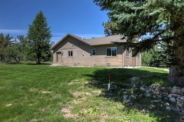 view of side of home featuring a yard