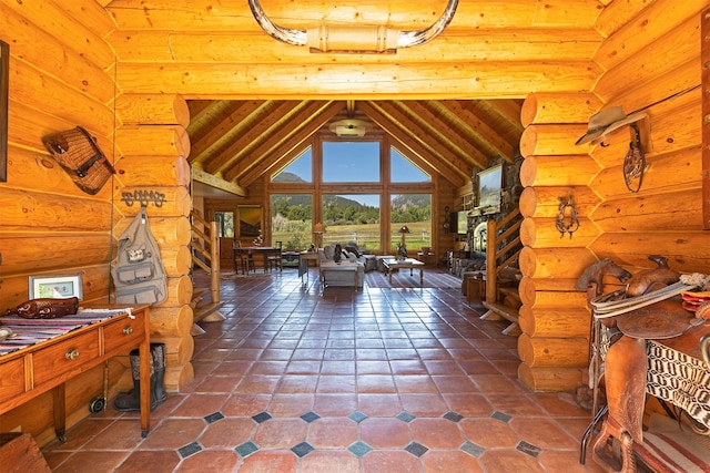 interior space featuring log walls, high vaulted ceiling, dark tile floors, and beam ceiling