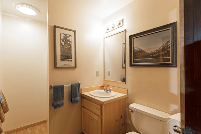 bathroom featuring toilet, hardwood / wood-style flooring, and oversized vanity