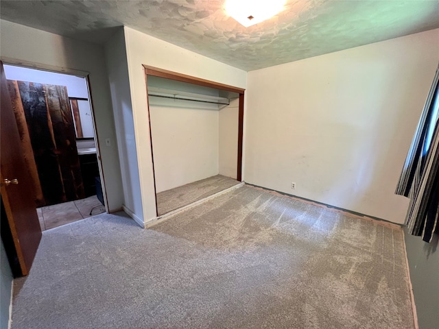 unfurnished bedroom with light carpet and a closet