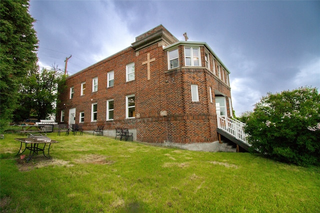 view of side of property with a yard