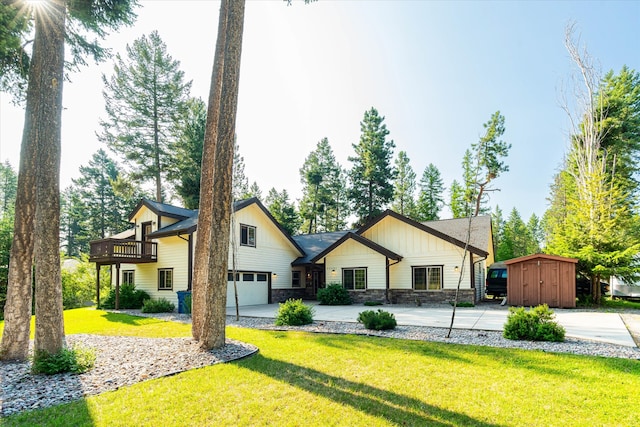 view of front of property with a front yard, a shed, and a garage