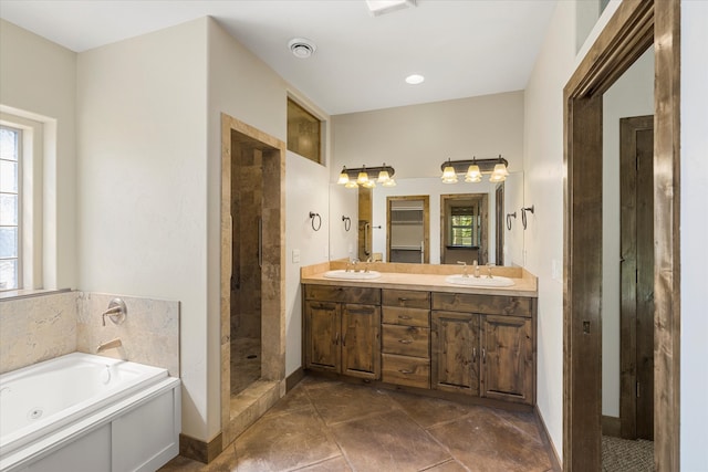 bathroom featuring a wealth of natural light, tile flooring, separate shower and tub, double sink, and large vanity