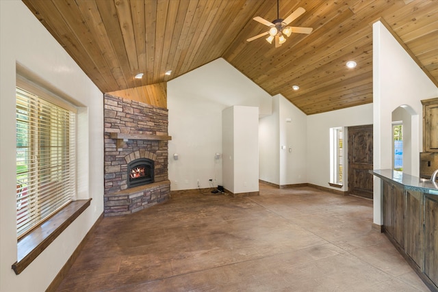 unfurnished living room featuring ceiling fan, a fireplace, and wooden ceiling