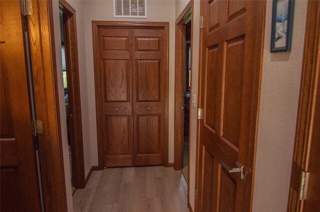 corridor featuring wood-type flooring