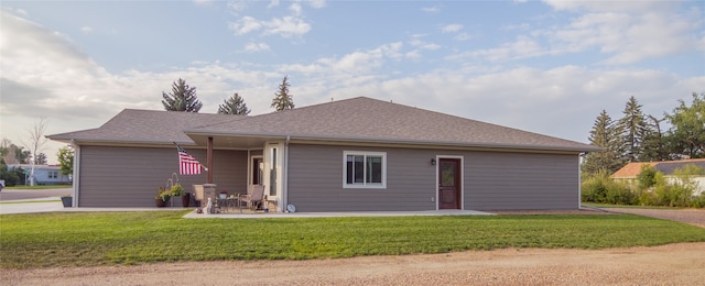 view of front of house with a patio and a front yard