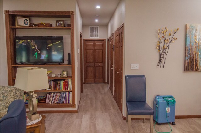 hall with hardwood / wood-style flooring