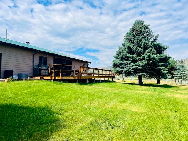 view of yard featuring central air condition unit and a wooden deck