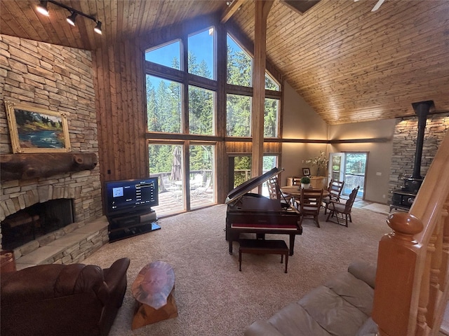 living room featuring carpet, high vaulted ceiling, a fireplace, and wood ceiling