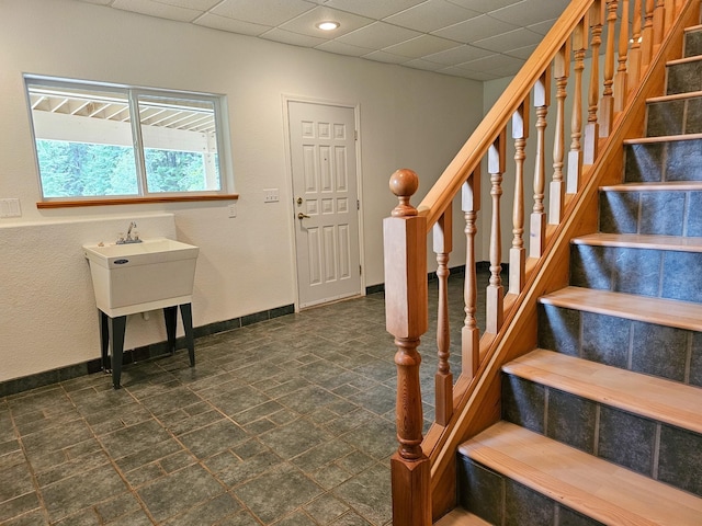 3971 Glen Lake Rd, Eureka, MT 59917 - stairway featuring a paneled ceiling and stone finish flooring
