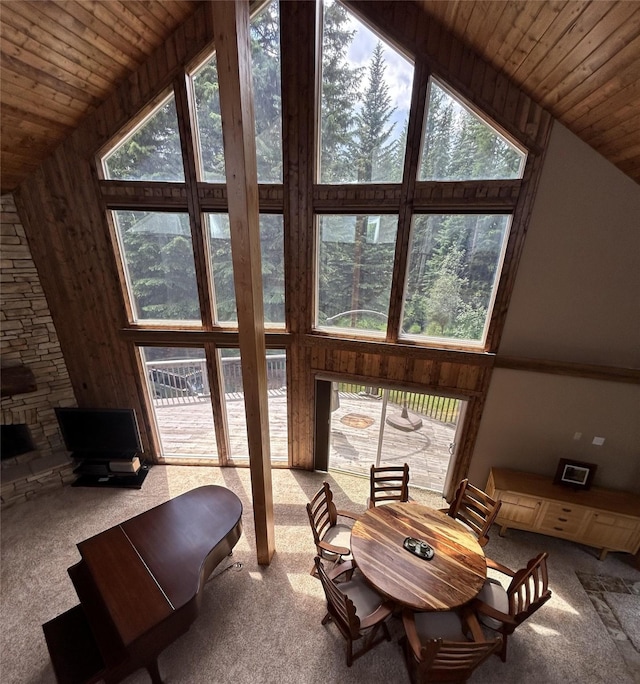 living room featuring carpet, wooden ceiling, high vaulted ceiling, and a fireplace