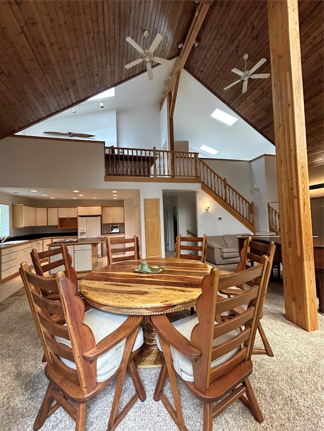 3971 Glen Lake Rd, Eureka, MT 59917 - dining room with ceiling fan, wood ceiling, high vaulted ceiling, light colored carpet, and stairway