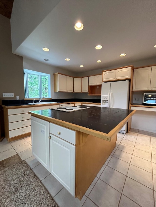 3971 Glen Lake Rd, Eureka, MT 59917 - kitchen with a kitchen island, white appliances, light tile patterned flooring, recessed lighting, and tile counters