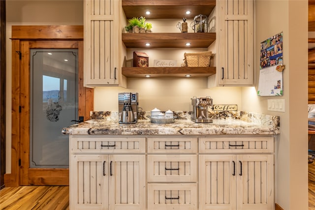 kitchen with light stone counters and light hardwood / wood-style floors