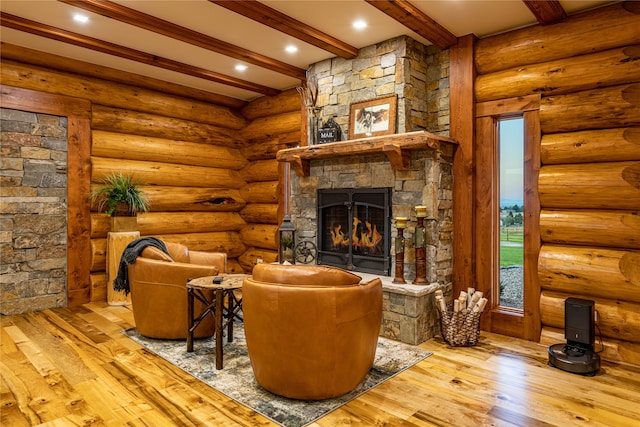 living room with beamed ceiling, wood-type flooring, and rustic walls