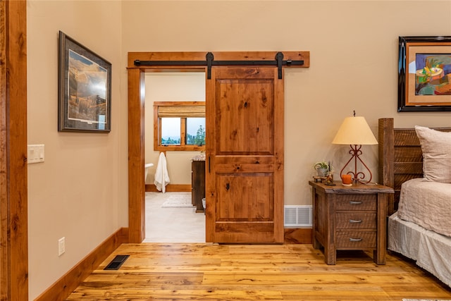 interior space featuring light hardwood / wood-style floors and a barn door