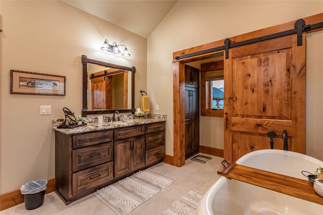 bathroom featuring vaulted ceiling, vanity, tile patterned flooring, and a tub to relax in