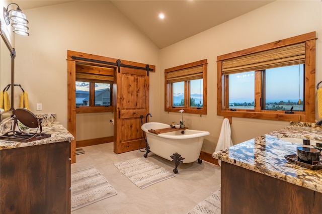 bathroom featuring lofted ceiling, tile patterned floors, a tub to relax in, and a wealth of natural light